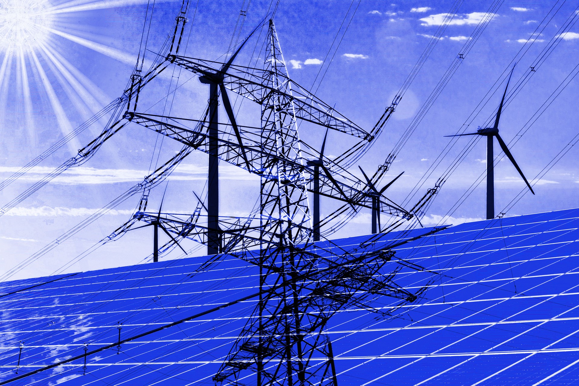 Eine Stromleitung und Energie aus Sonne und Wind